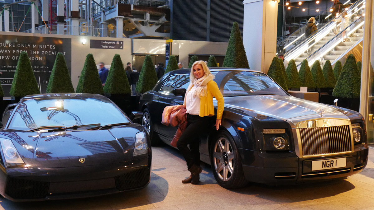 Blogger Ana-Maria Hota posing in front of Ferrari-Rolls-Roys